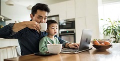 dad working on family financial planning on a computer