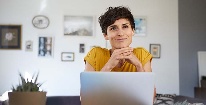 woman pondering money management tips in front of computer