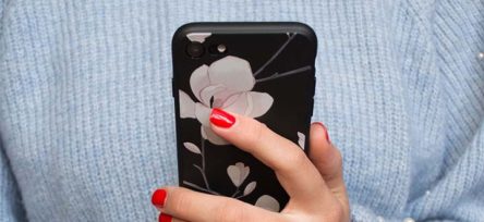 woman holding phone looking for money saving apps