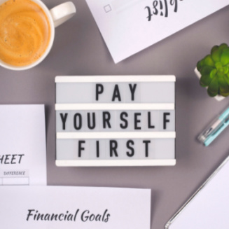 Pay Yourself First spelled on a sign board.