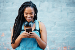 Woman happy with high yield savings account on mobile phone